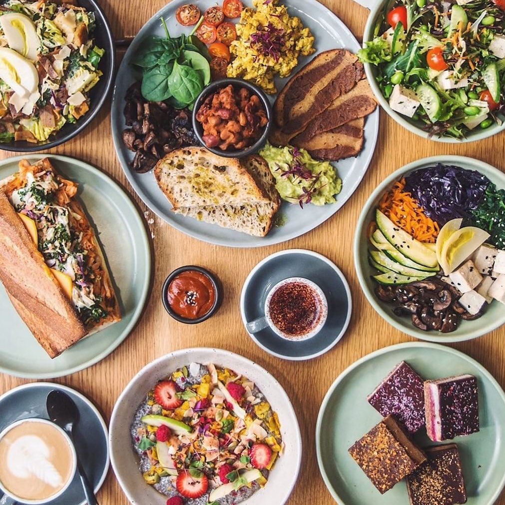 Table full of delicious vegan food and desserts