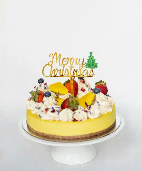 Merry Christmas Cake Topper, placed on top of one of Raw Passion's Vegan Cakes