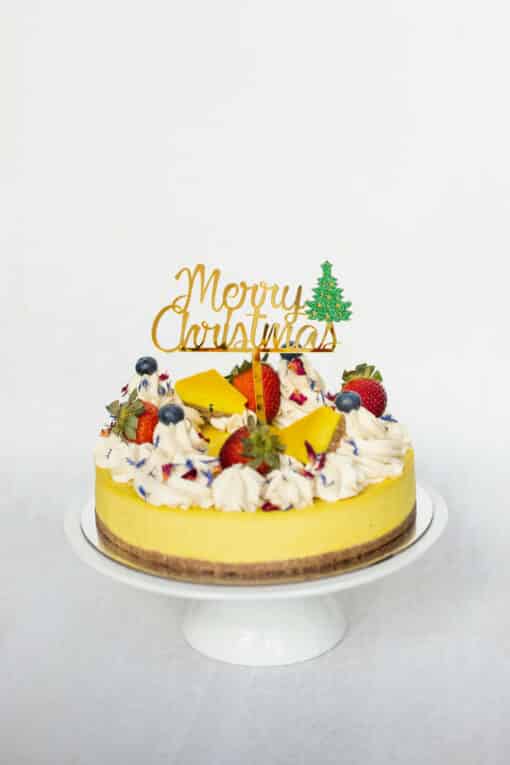 Merry Christmas Cake Topper, placed on top of one of Raw Passion's Vegan Cakes