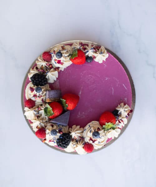 Close-up of creamy strawberry, blueberry & blackberry layers in Raw Passion’s vegan Berrylicious Cake