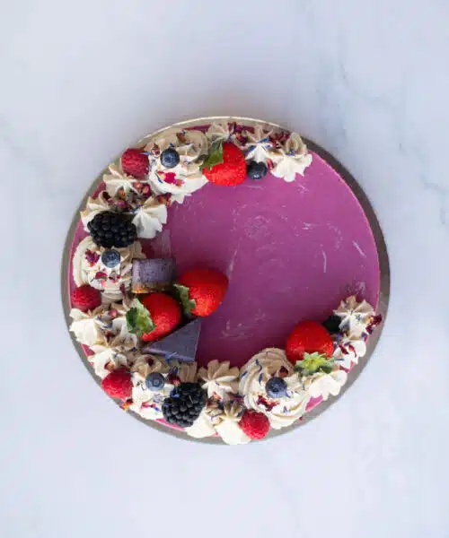 Close-up of creamy strawberry, blueberry & blackberry layers in Raw Passion’s vegan Berrylicious Cake