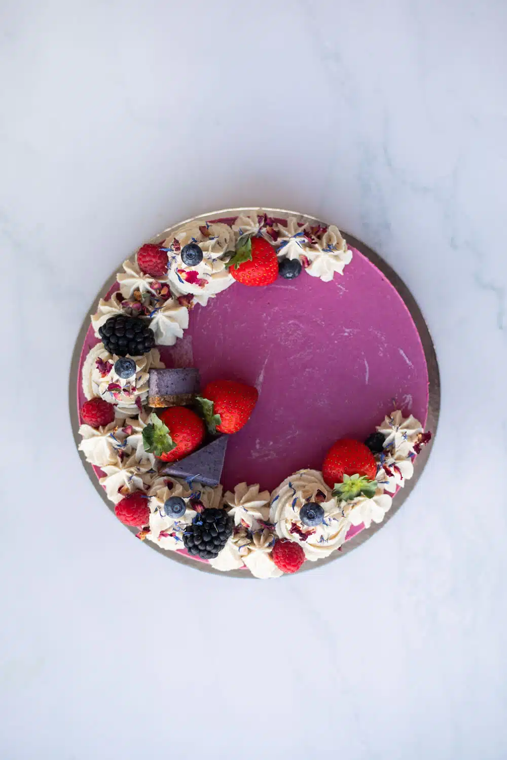Close-up of creamy strawberry, blueberry & blackberry layers in Raw Passion’s vegan Berrylicious Cake