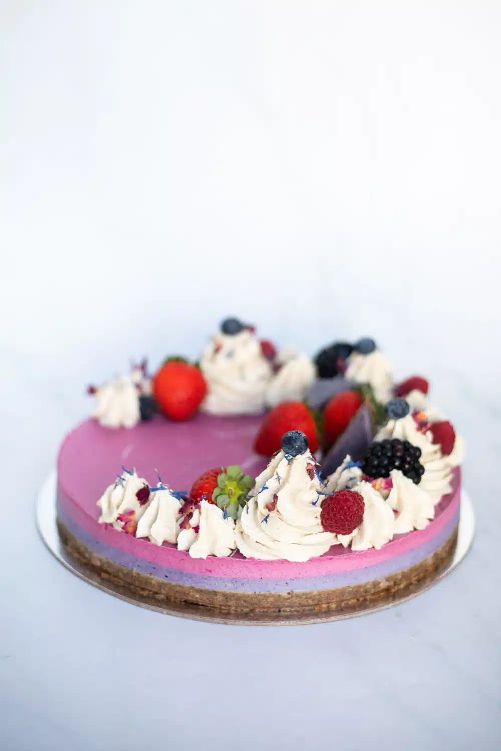 Raw Passion Berrylicious Cake with strawberry, blueberry & blackberry layers topped with vanilla icing